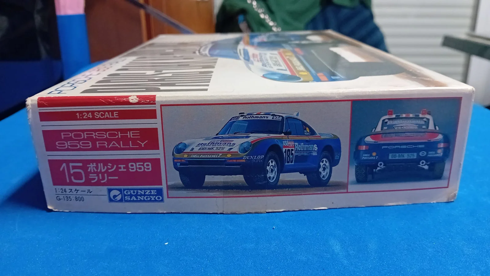 Box art of the Gunze Sangyo 1:24 scale Porsche 959 Rally Paris-Dakar High Rider plastic model kit featuring the #185 Rothmans livery