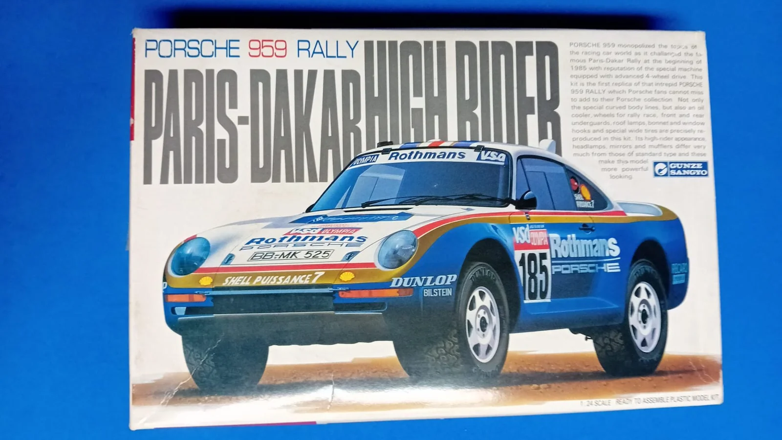 Box art of the Gunze Sangyo 1:24 scale Porsche 959 Rally Paris-Dakar High Rider plastic model kit featuring the #185 Rothmans livery