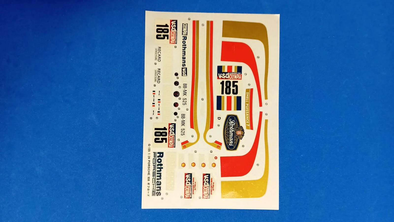Box art of the Gunze Sangyo 1:24 scale Porsche 959 Rally Paris-Dakar High Rider plastic model kit featuring the #185 Rothmans livery
